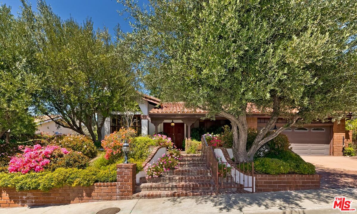 a front view of a house with yard