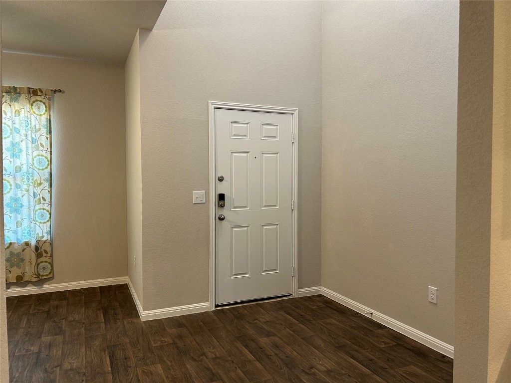 2212 Baugh Road Austin, TX 78754 - Photo 12 of 36 Entryway featuring dark wood-type flooring and a textured wall