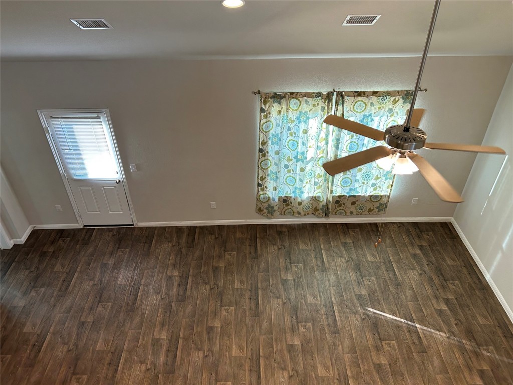 2212 Baugh Road Austin, TX 78754 - Photo 14 of 36 Empty room with dark wood-style floors, ceiling fan, and recessed lighting