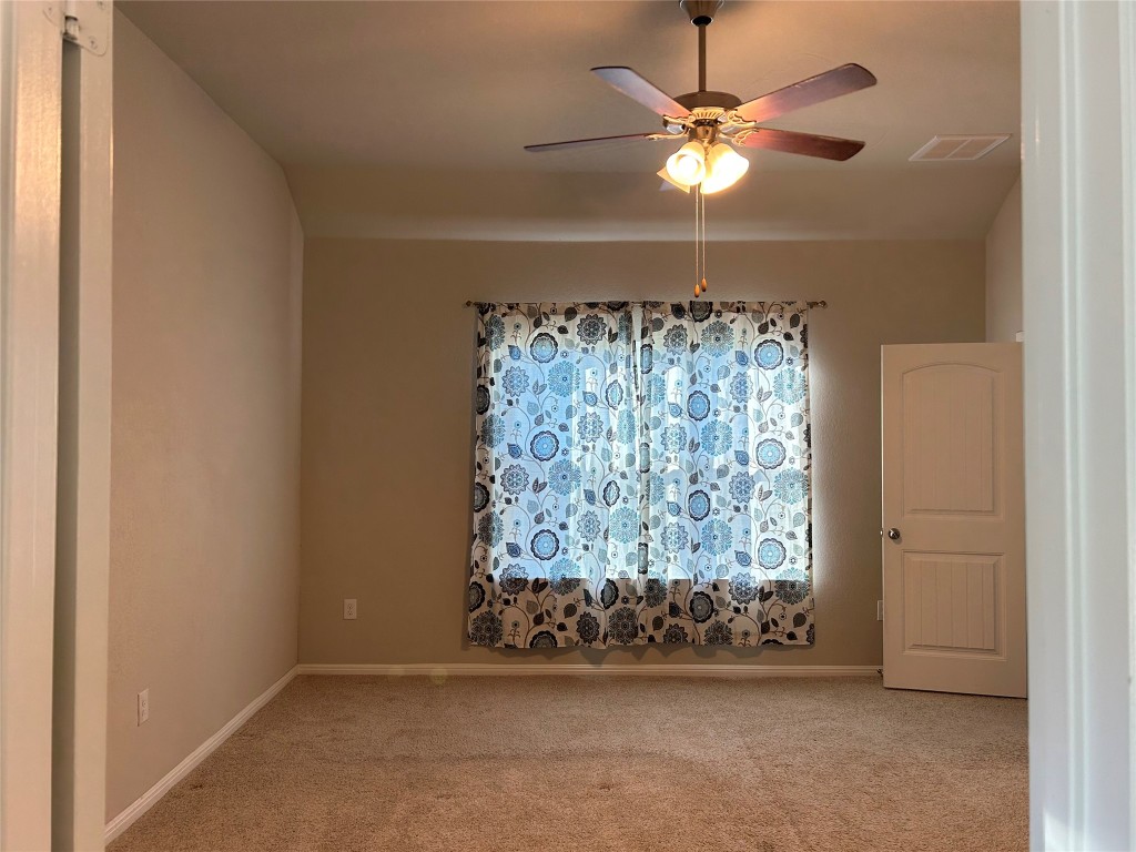 2212 Baugh Road Austin, TX 78754 - Photo 15 of 36 Spare room featuring carpet and ceiling fan