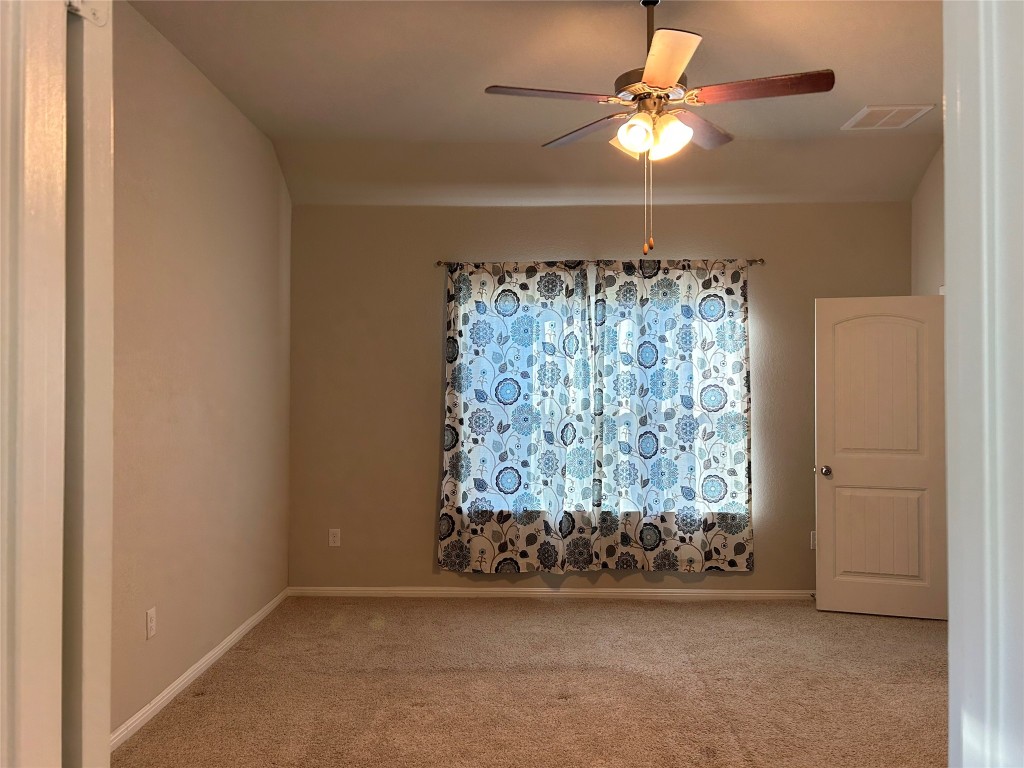 2212 Baugh Road Austin, TX 78754 - Photo 16 of 36 Unfurnished room with carpet and a ceiling fan
