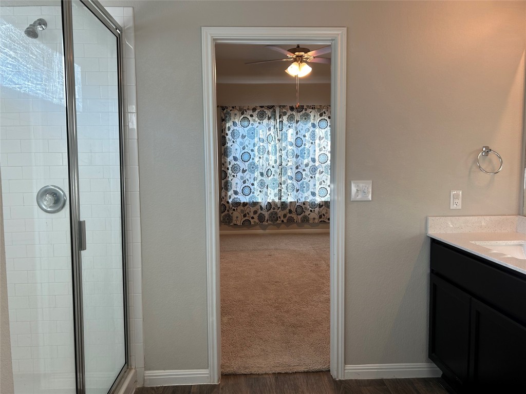 2212 Baugh Road Austin, TX 78754 - Photo 17 of 36 Full bath with a walking-in shower, vanity, and dark wood finished floors