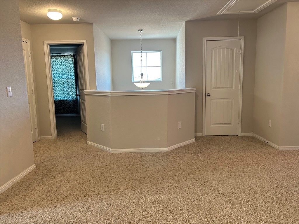 2212 Baugh Road Austin, TX 78754 - Photo 22 of 36 Unfurnished room with attic access and light carpet