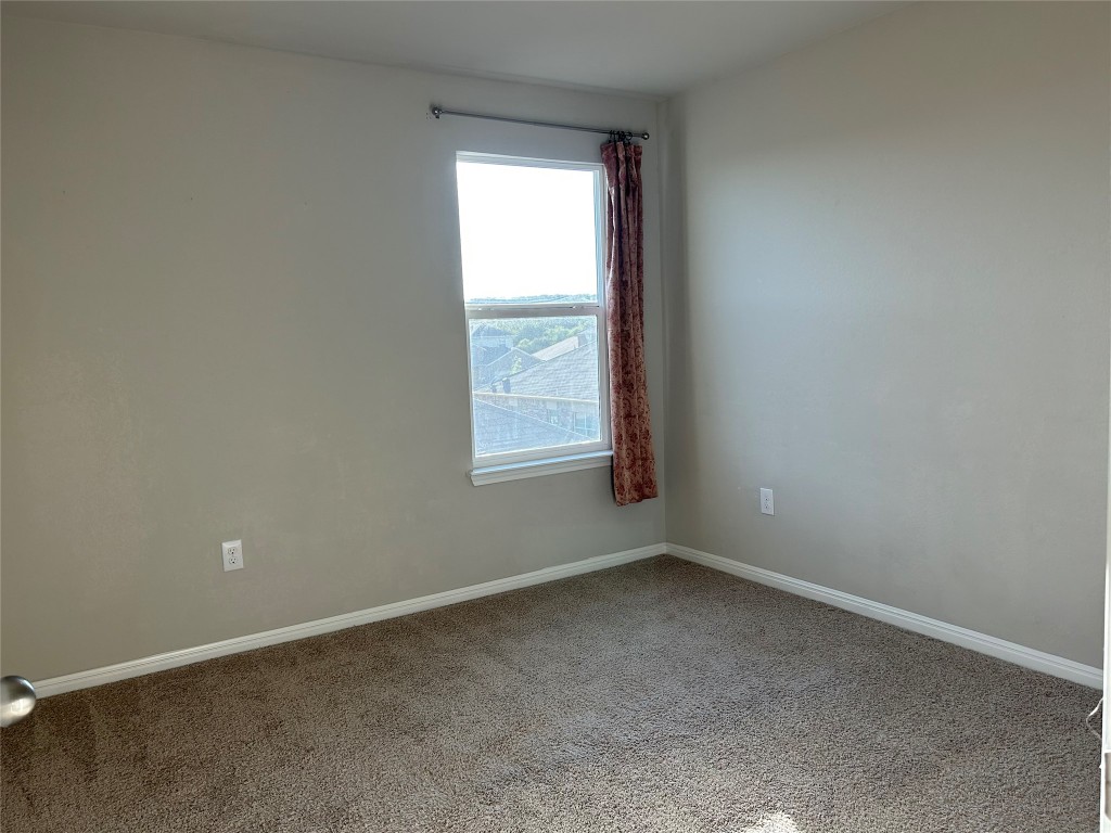 2212 Baugh Road Austin, TX 78754 - Photo 23 of 36 Spare room with carpet floors and baseboards