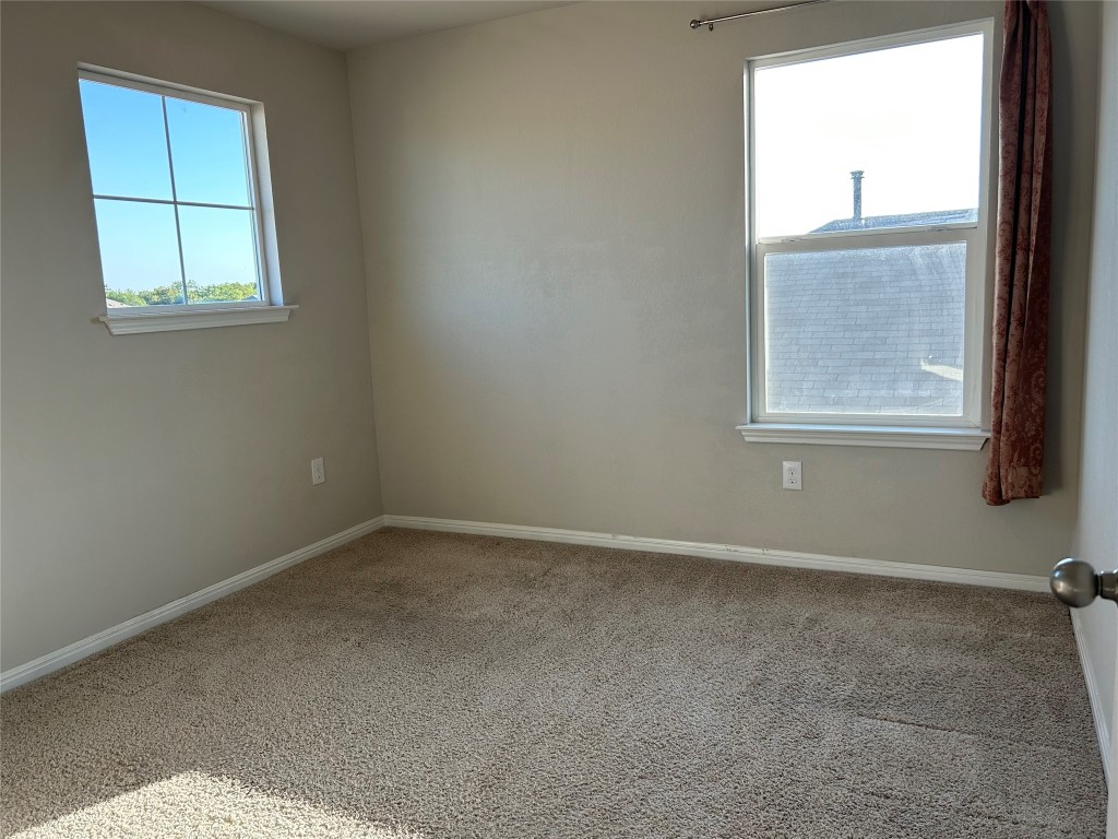 2212 Baugh Road Austin, TX 78754 - Photo 24 of 36 Spare room with carpet and baseboards
