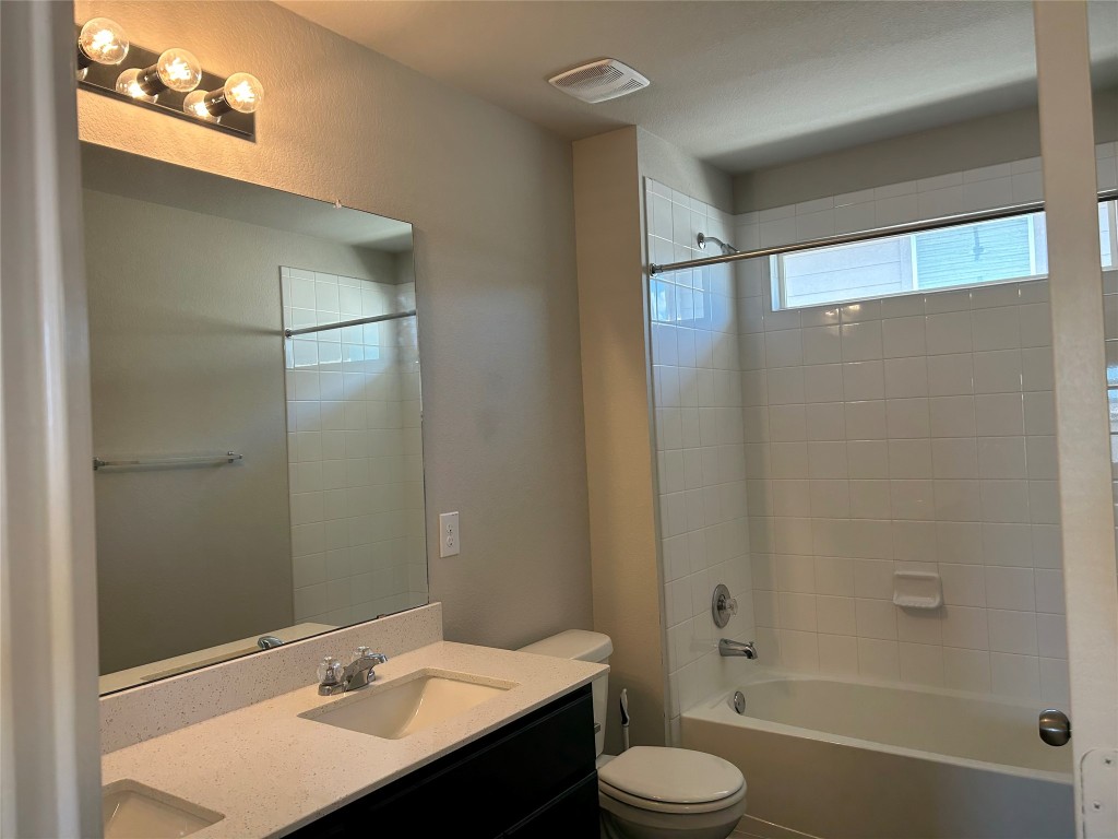 2212 Baugh Road Austin, TX 78754 - Photo 26 of 36 The 2nd bathroom with double vanity and shower / bath combination