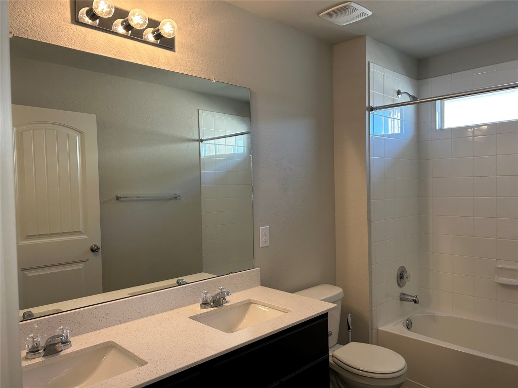 2212 Baugh Road Austin, TX 78754 - Photo 29 of 36 The 2nd full bathroom with double vanity and washtub / shower combination