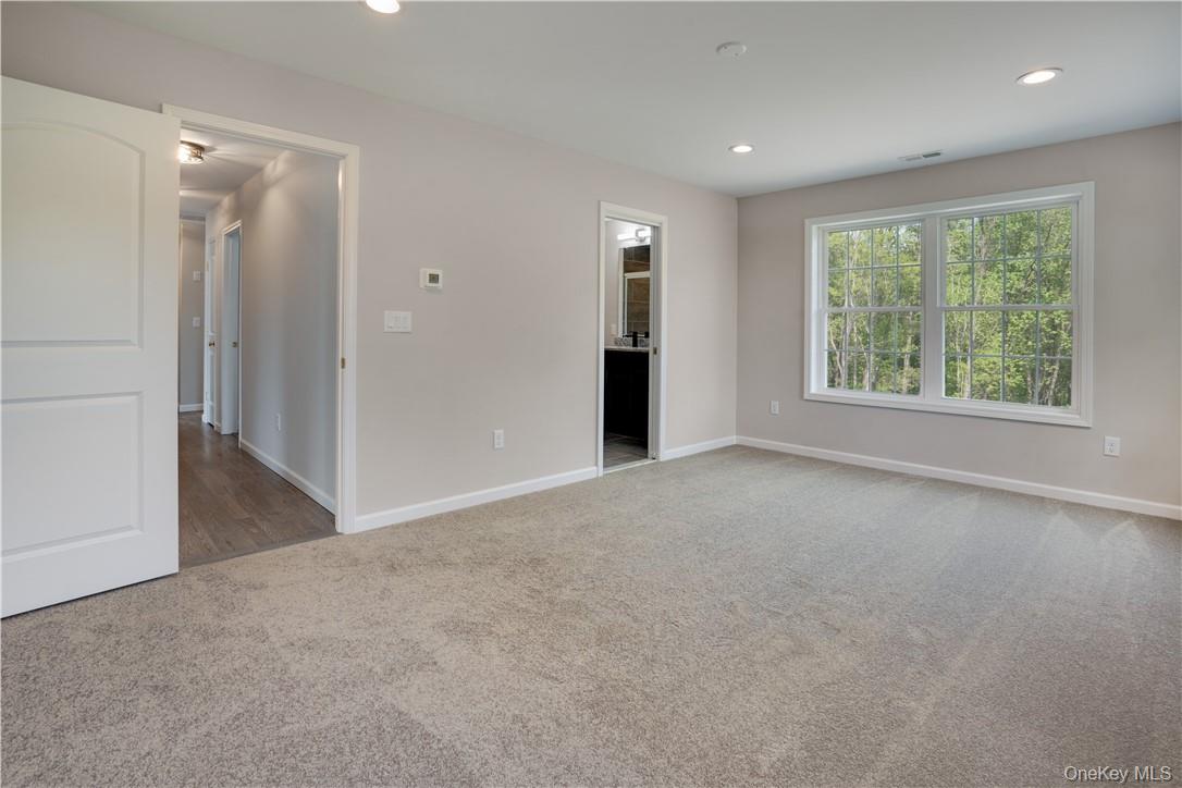 991 Freedom Road Pleasant Valley, NY 12569 - Photo 11 of 23 a view of a big room with windows and chandelier fan