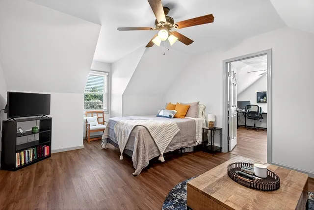 a bedroom with furniture and a flat screen tv