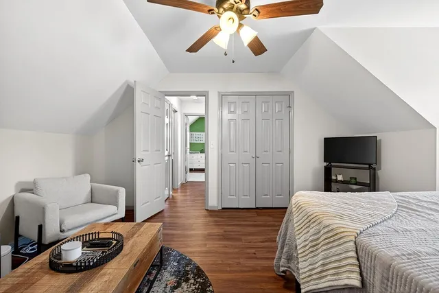 a bedroom with bed and a chandelier