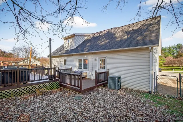 a view of a house with wooden deck and furniture