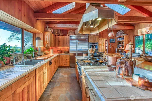 a bed sitting in a bedroom next to a large window