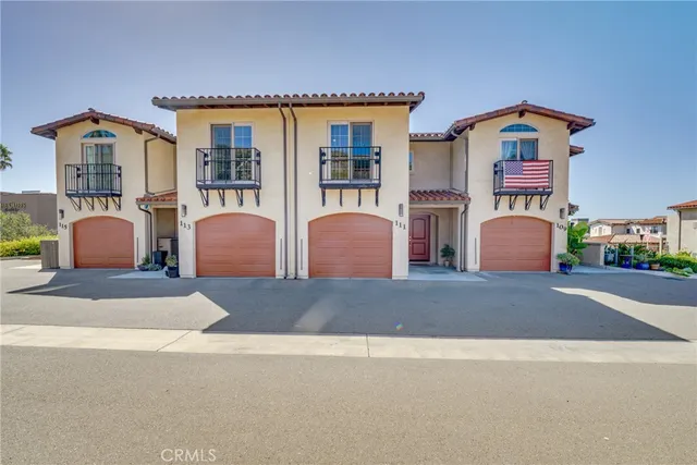 a front view of a house with garage and parking