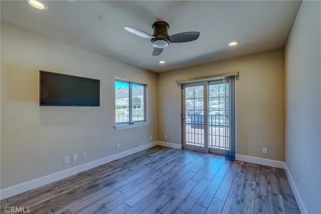 a bedroom with a bed and ceiling fan