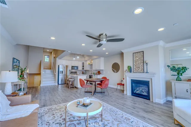a large kitchen with lots of counter space wooden floor and stainless steel appliances