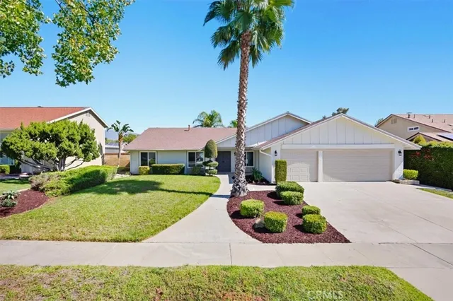 a front view of a house with a garden and entryway