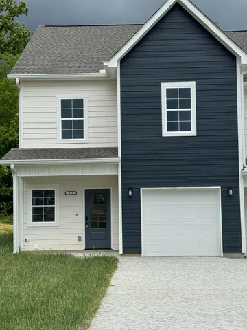 a front view of a house with garage