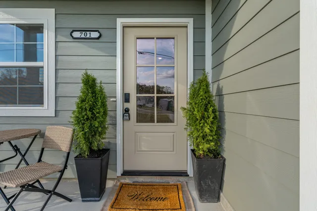 a view of front door and potted plants