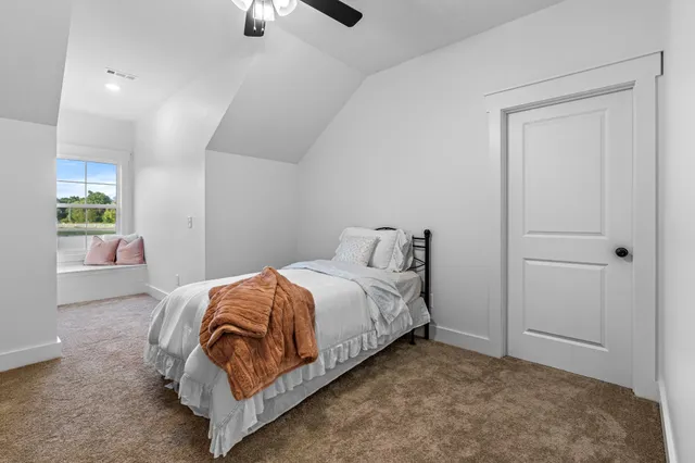 a bedroom with a bed and a lamp