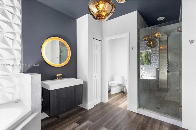 a bathroom with a sink a light fixture and a mirror