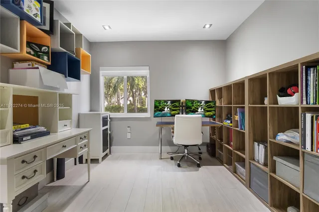 a view of a workspace with furniture and a window