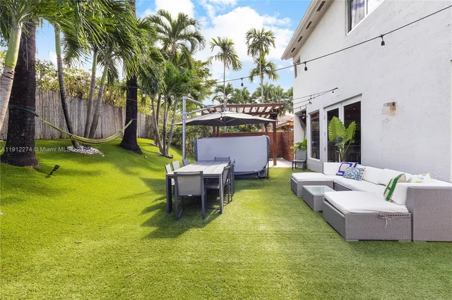 a swimming pool with outdoor seating and yard