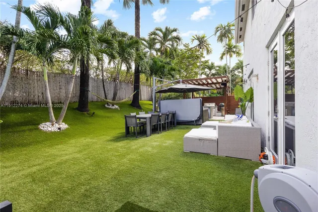 a backyard of a house with table and chairs