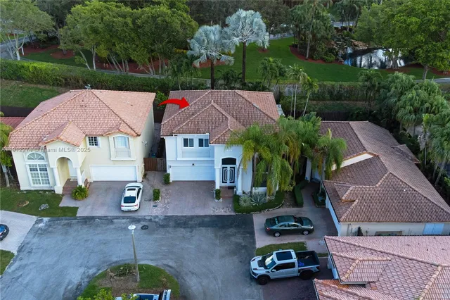 an aerial view of a house with garden space and street view