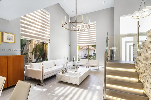 a living room with furniture and a chandelier