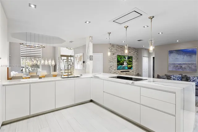 a kitchen with sink and white cabinets