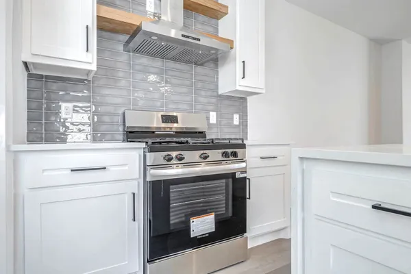 a kitchen with a stove and a microwave