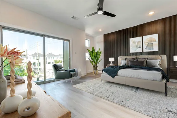 a spacious bedroom with a large bed and a large window