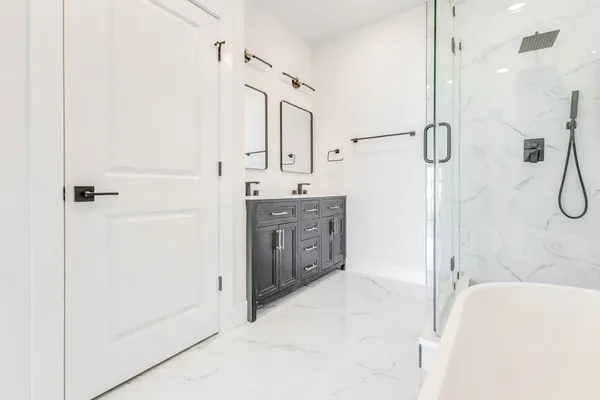 a spacious bathroom with a sink a mirror and a shower