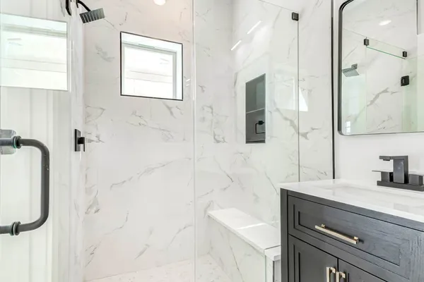 a bathroom with a sink a toilet and shower