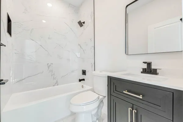 a bathroom with a sink a toilet and a bathtub