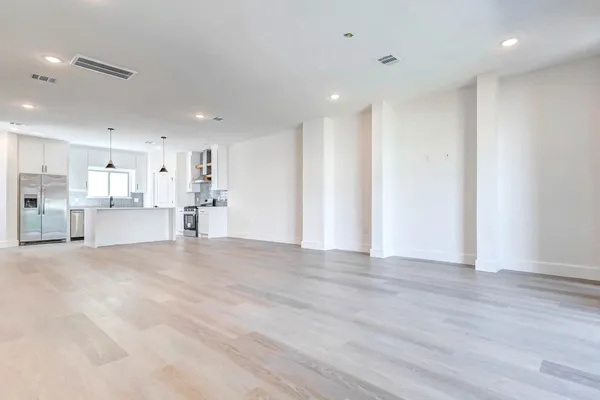 a view of a kitchen with a sink and a refrigerator