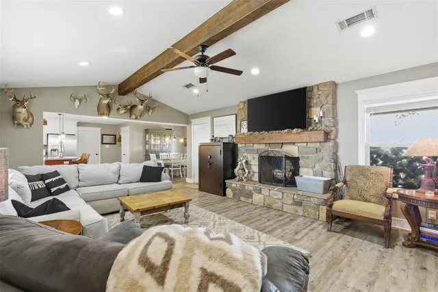 a living room with furniture a fireplace and a flat screen tv