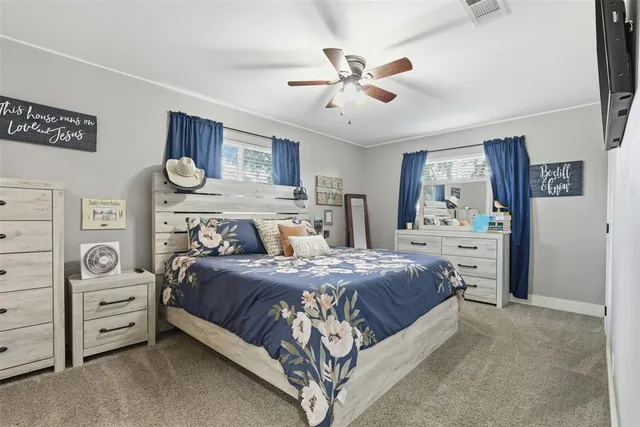 a bedroom with a bed and ceiling fan