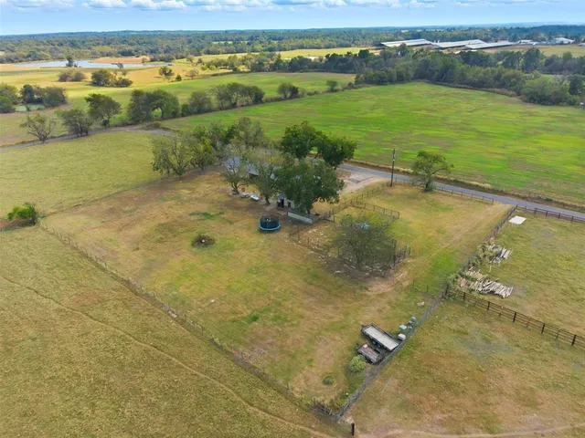 an aerial view of ocean with residential houses with outdoor space