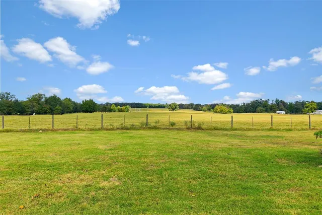a view of a lake with houses in the background
