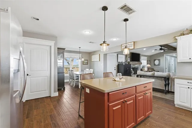 a room with stainless steel appliances kitchen island a island in the center