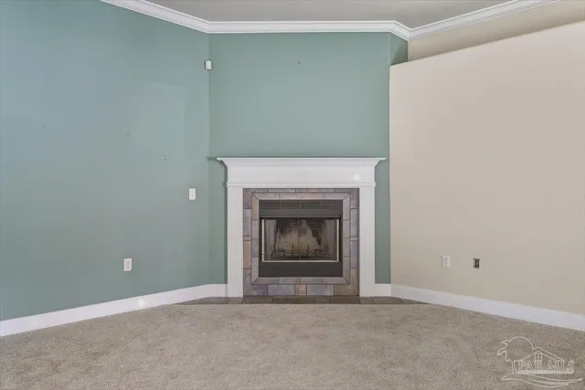 an empty room with chandelier fan and windows