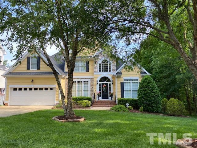 204 Challenge Road Raleigh, NC 27603 - Photo 1 of 42 a front view of a house with a garden and trees