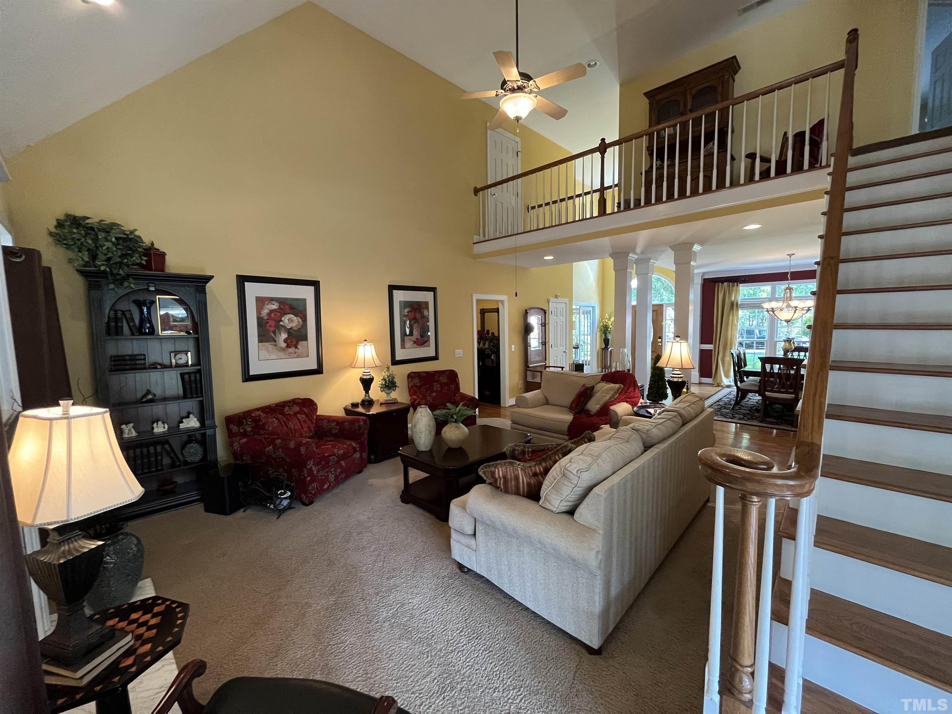 204 Challenge Road Raleigh, NC 27603 - Photo 12 of 42 a living room with furniture a rug and a chandelier
