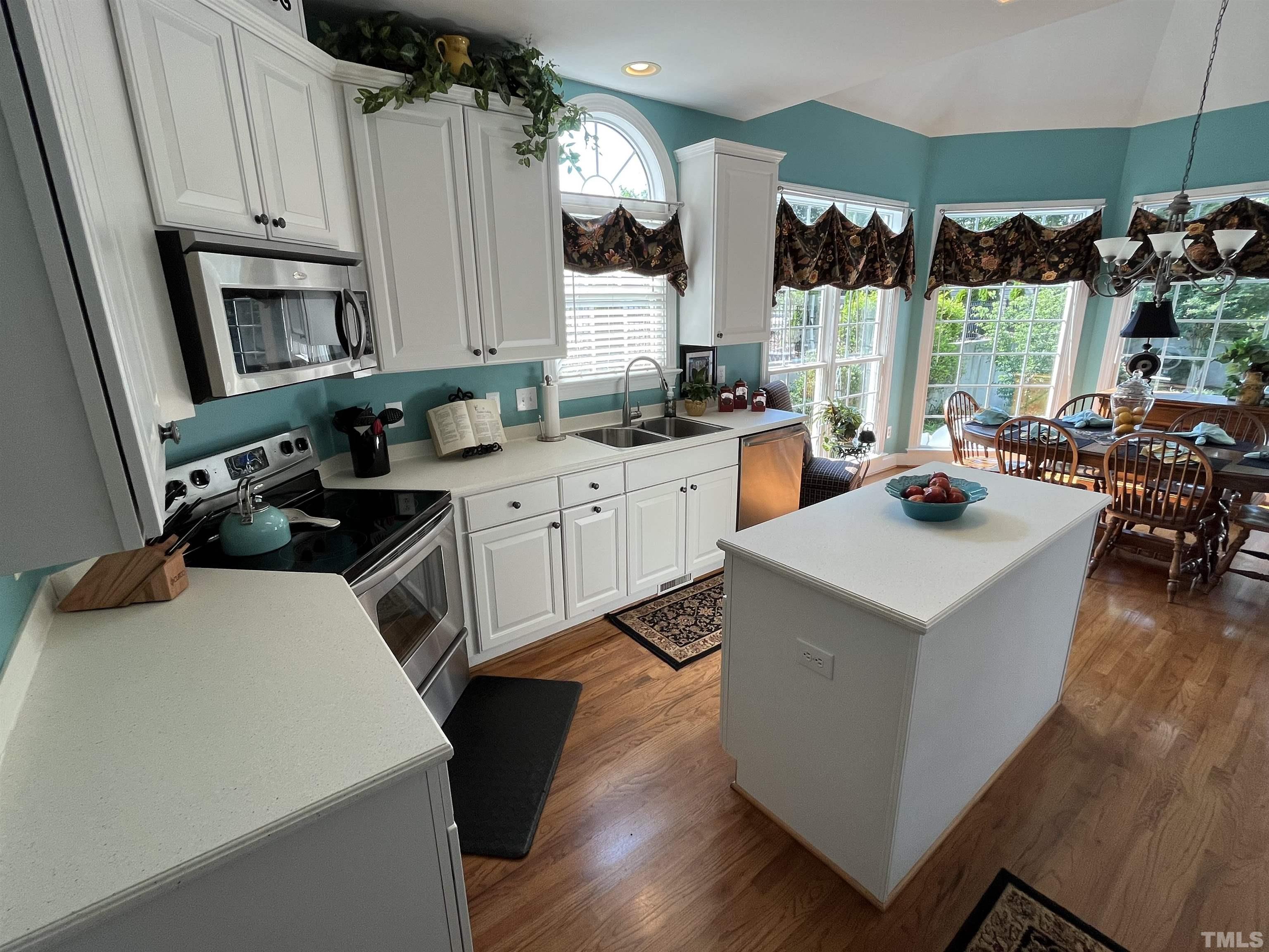 204 Challenge Road Raleigh, NC 27603 - Photo 16 of 42 a kitchen that has a sink a stove and a table in it