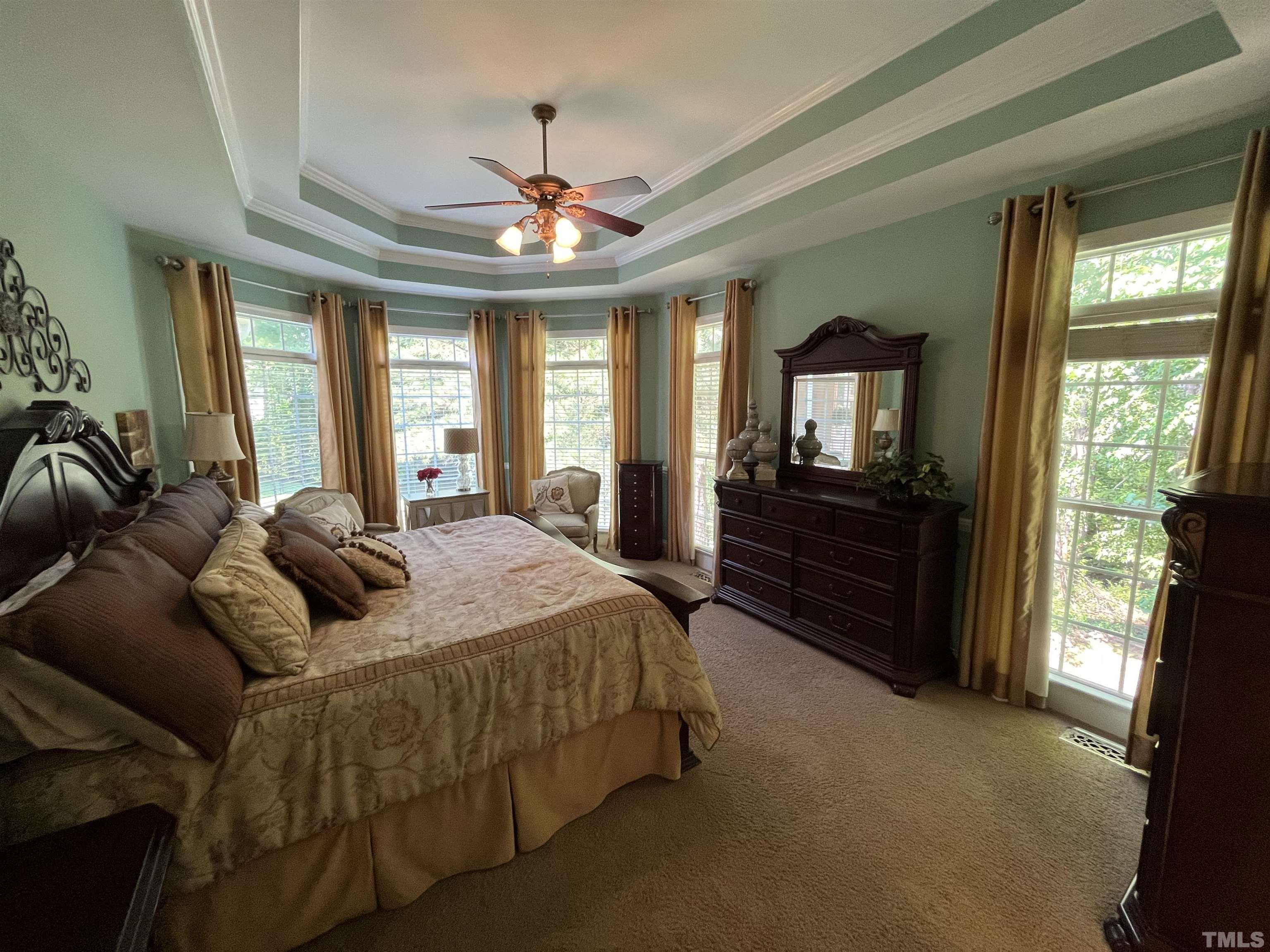 204 Challenge Road Raleigh, NC 27603 - Photo 21 of 42 a bedroom with a bed and wooden floor