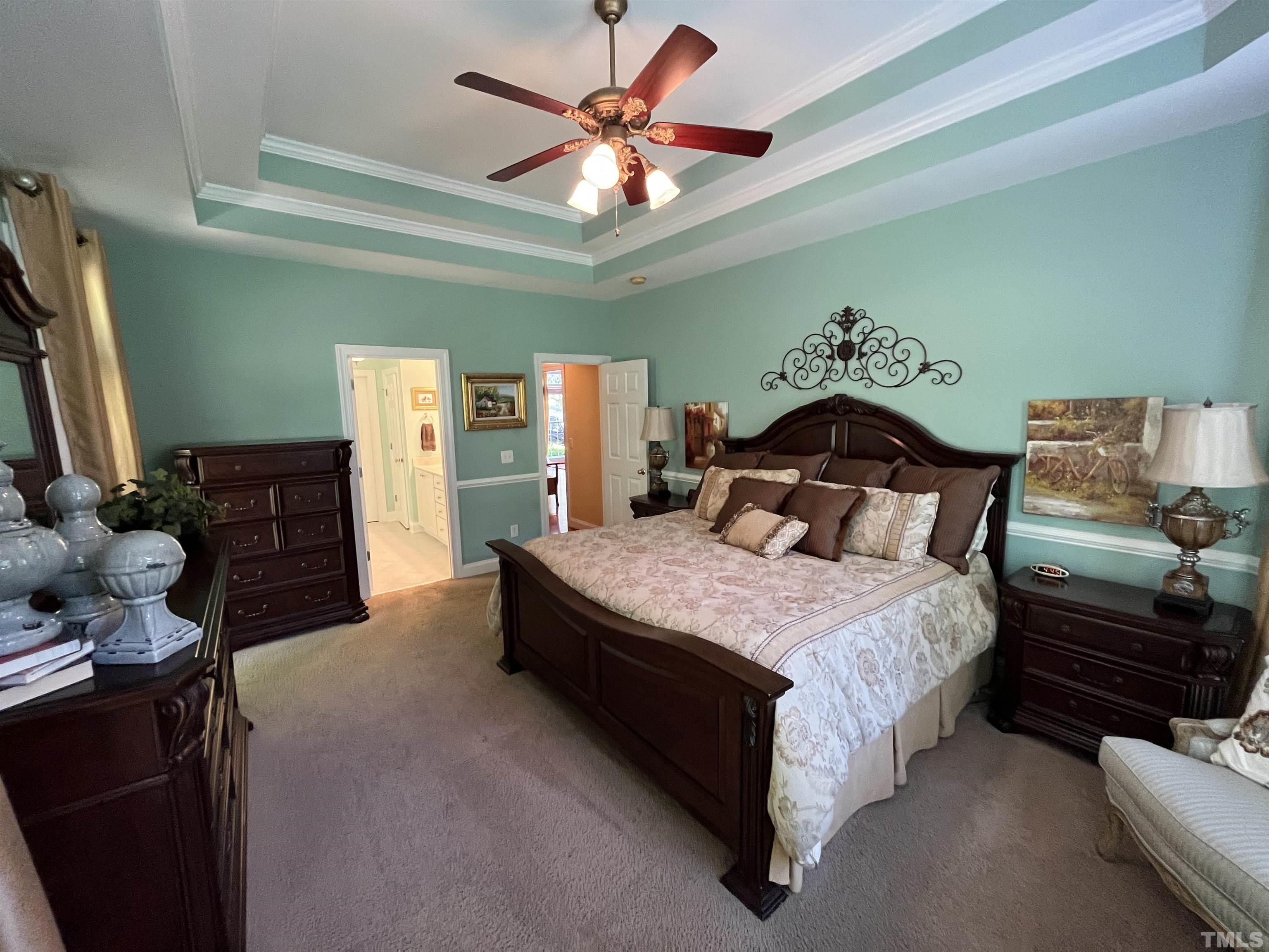 204 Challenge Road Raleigh, NC 27603 - Photo 22 of 42 a bedroom with a bed and a chandelier
