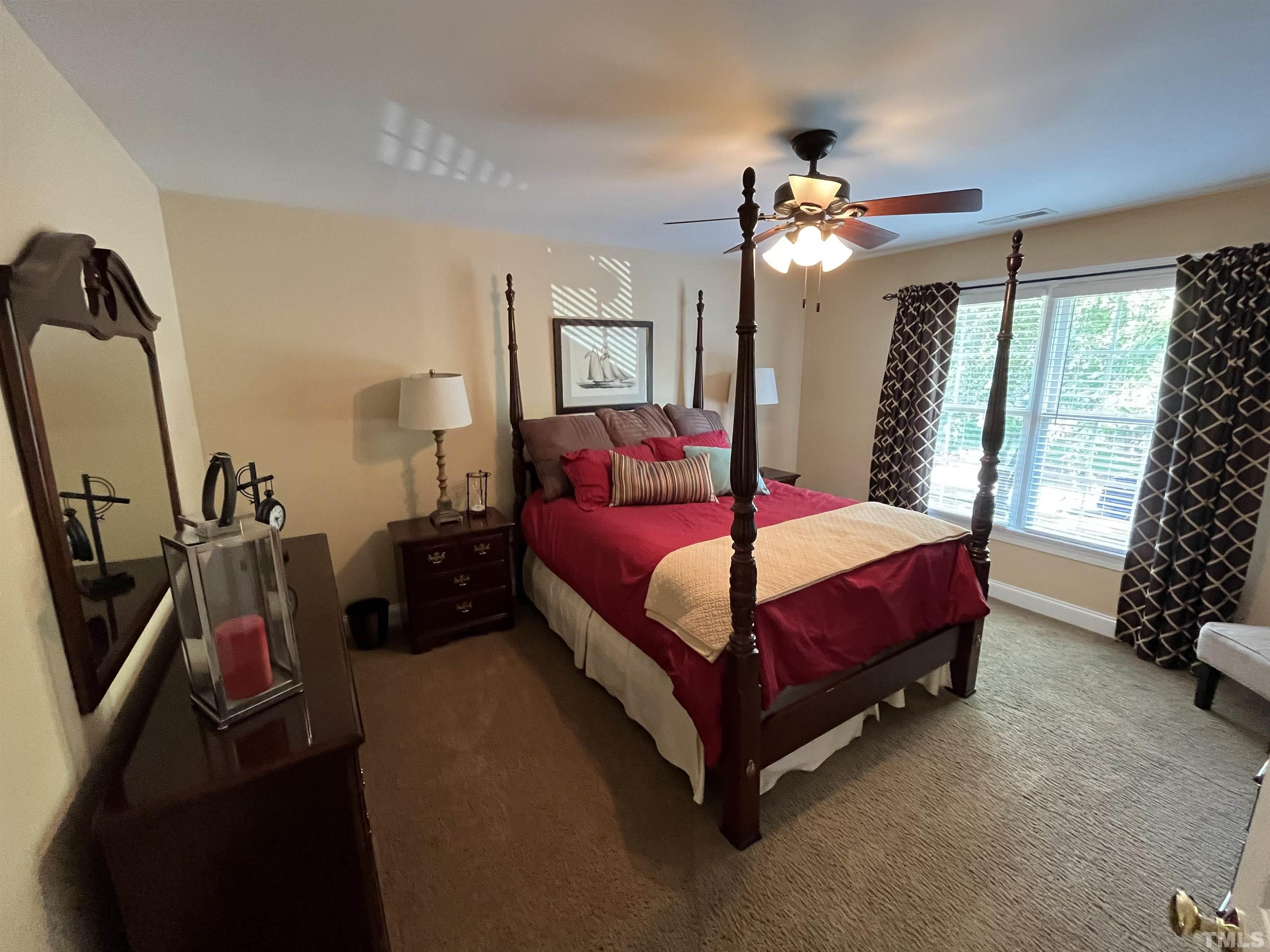 204 Challenge Road Raleigh, NC 27603 - Photo 29 of 42 a bedroom with a bed closet and a window