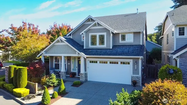 a front view of a house with a yard and fountain
