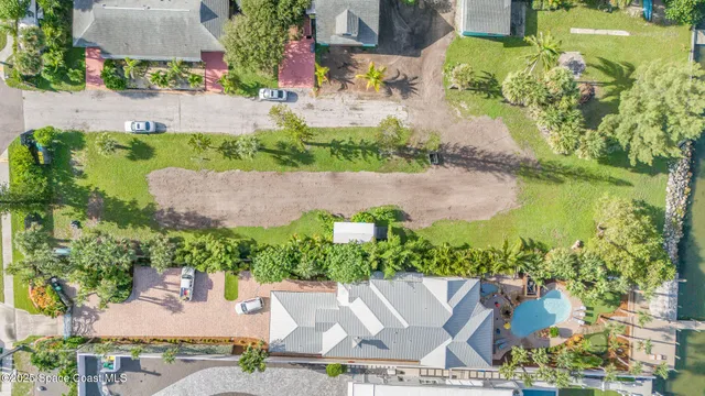 an aerial view of a house with a garden and lake view